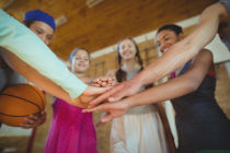 highschool kids with their hands stacked